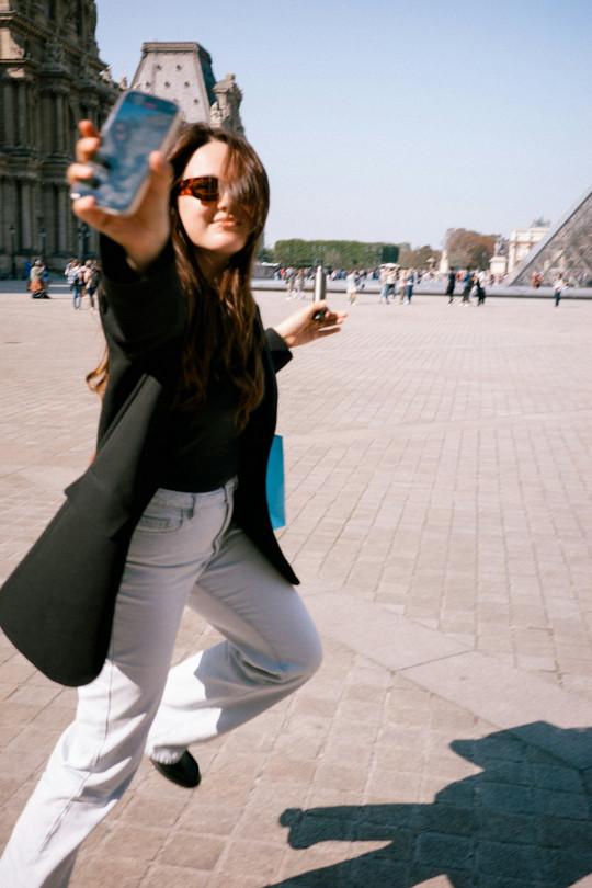 A woman taking a picture with her cell phone