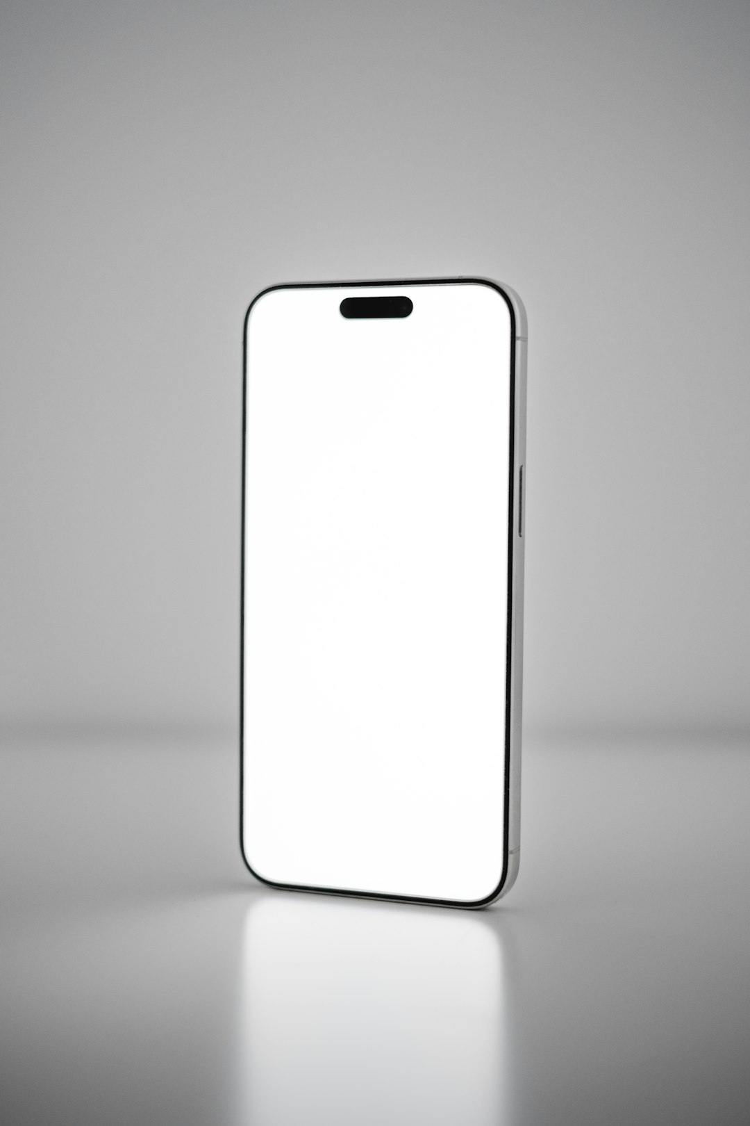 A white cell phone with a blank screen