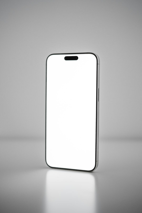 A white cell phone with a blank screen