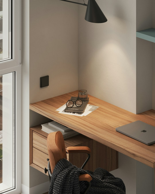 A wooden desk with a laptop on top of it