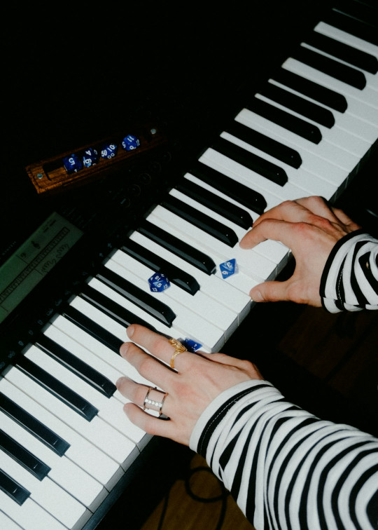 A person is playing an electronic piano