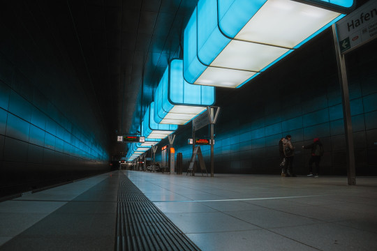 A subway station with people waiting for the train