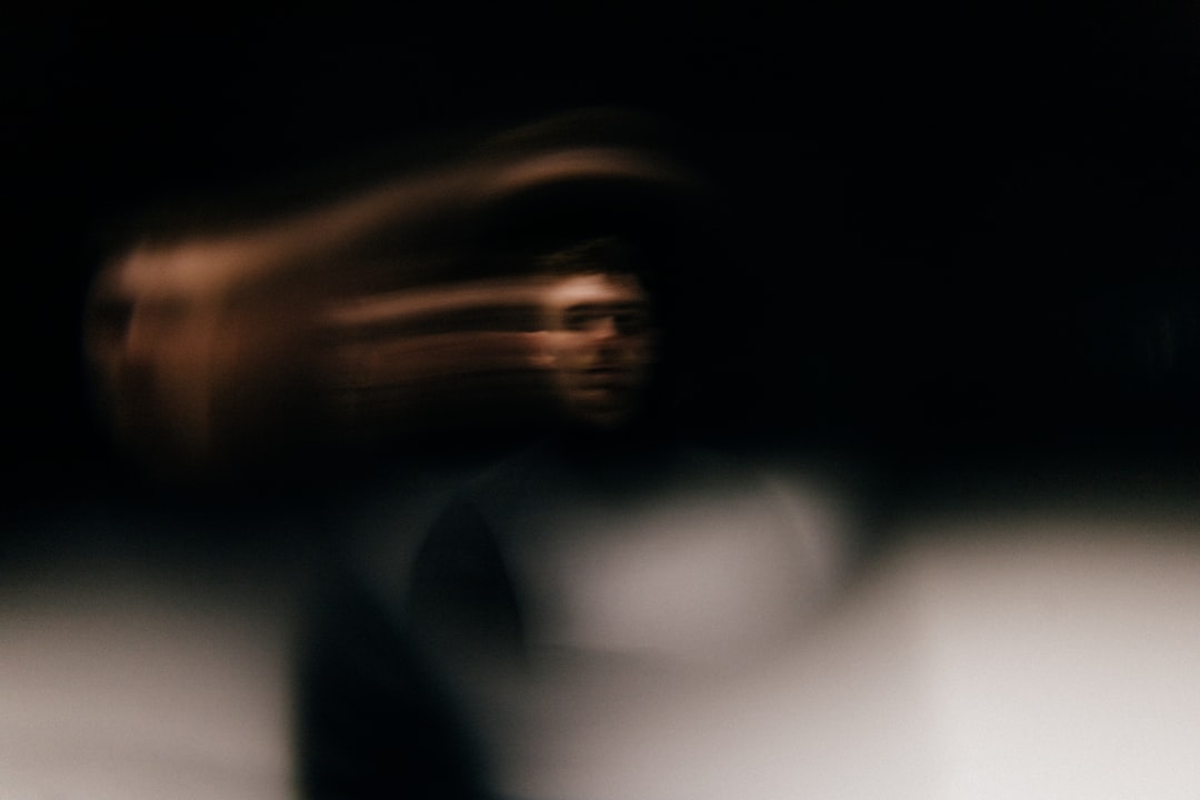 A blurry photo of a man in a dark room