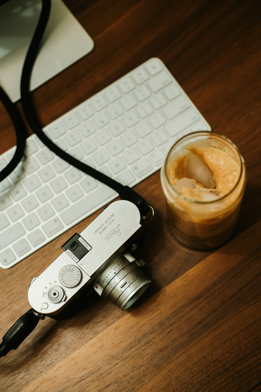 A camera and a cup of coffee on a desk