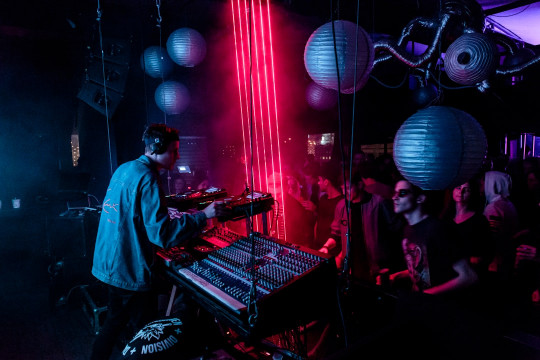 A man playing a keyboard in front of a group of people