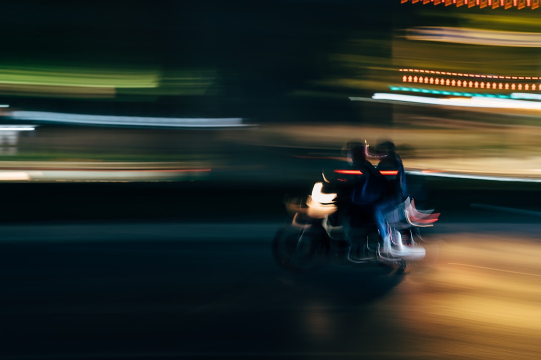 A blurry photo of two people on a motorcycle