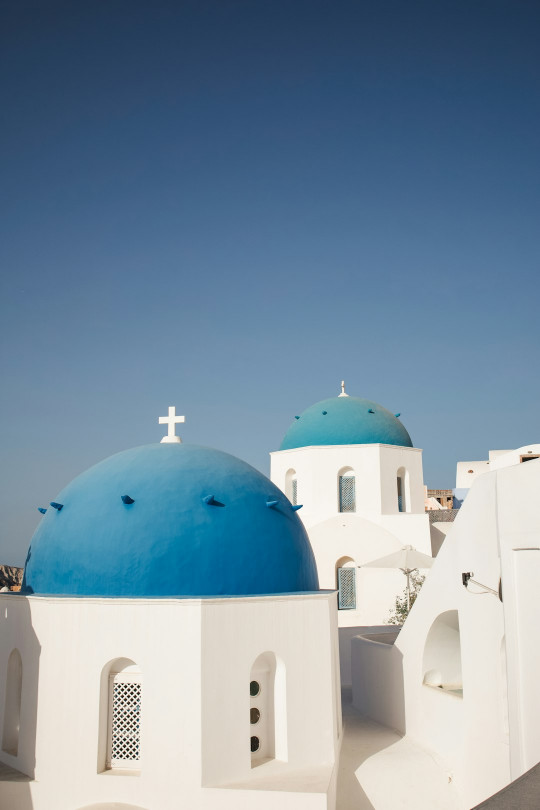 A blue and white building with a cross on top