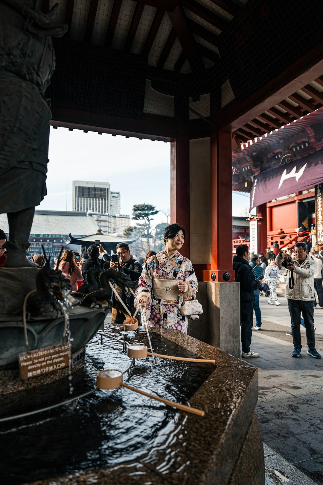 A group of people standing around a fountain