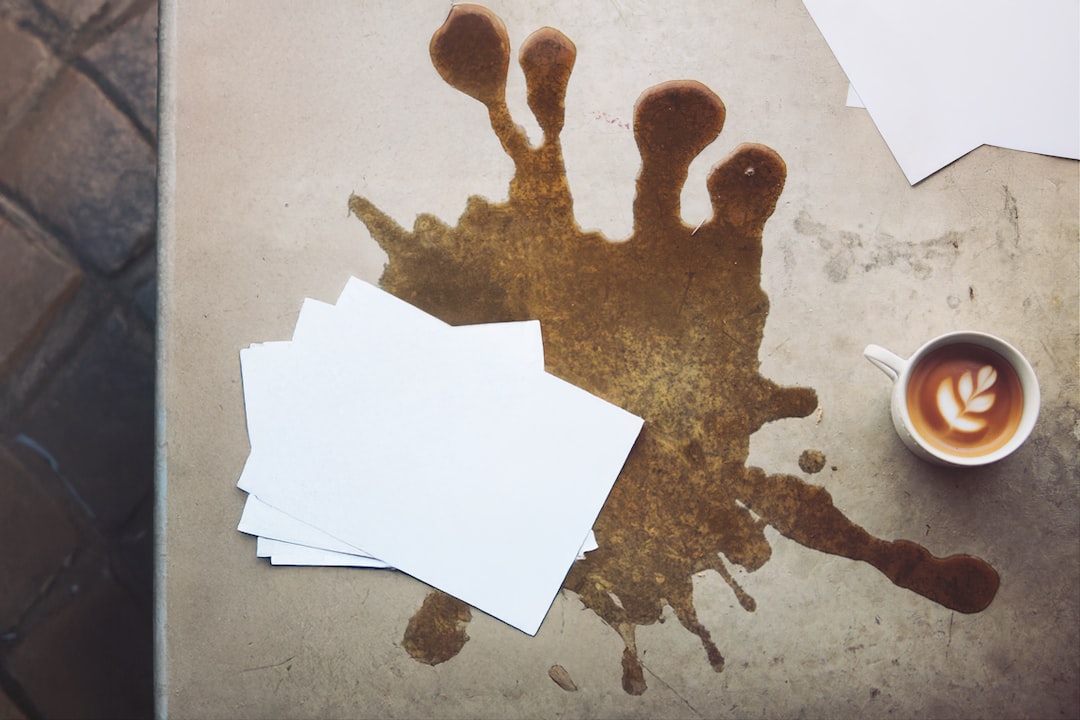 A table topped with papers and a cup of coffee