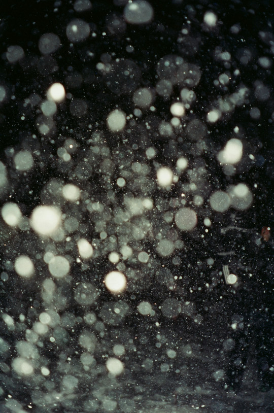 A black and white photo of snow falling