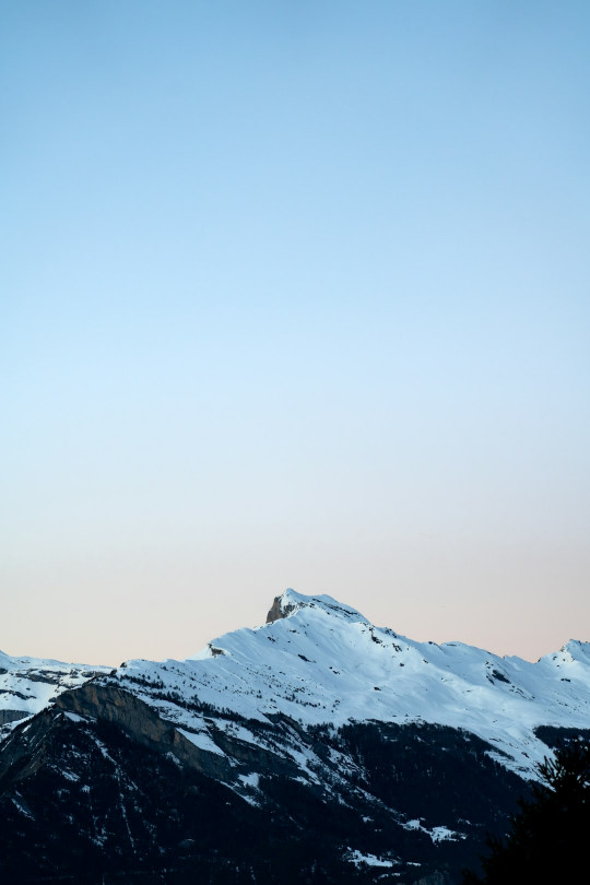 A snowboarder is doing a trick in the air