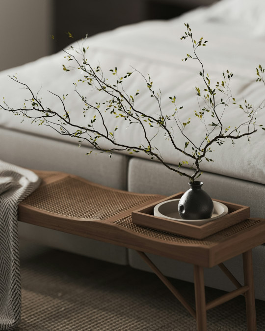 A bed with a tray with a plant on it