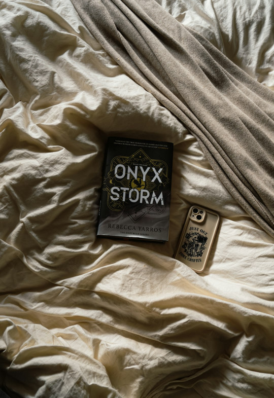 A book laying on top of a white bed