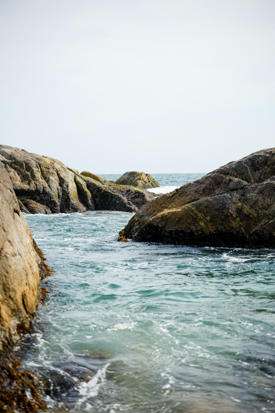 A body of water surrounded by large rocks