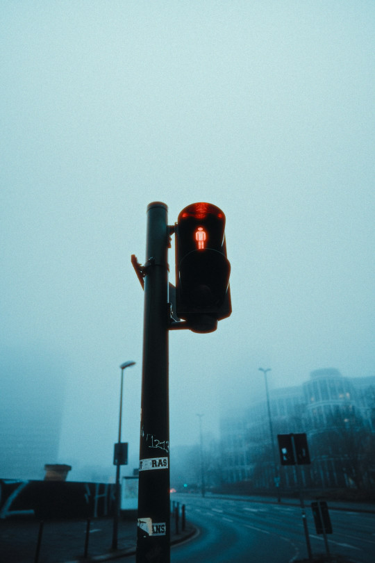 A traffic light sitting on the side of a road