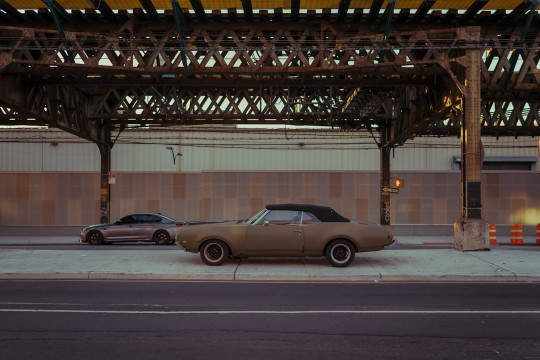 A couple of cars parked next to each other on a street