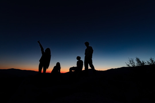 A group of people standing on top of a hill