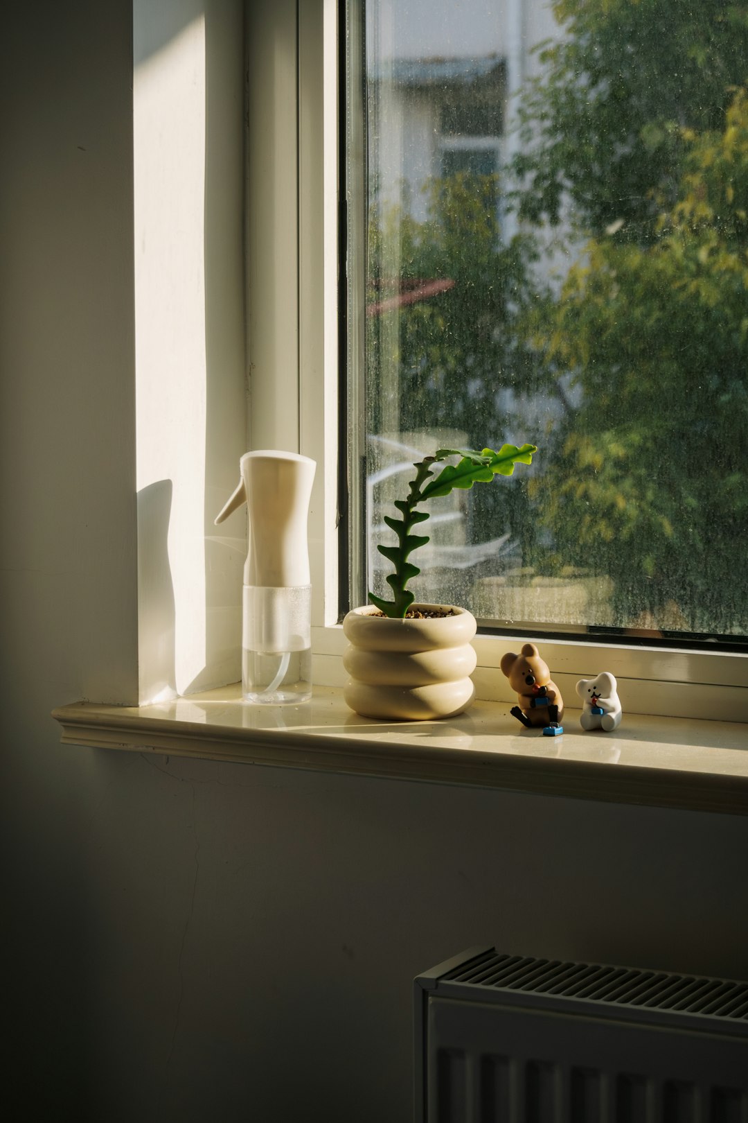 A window sill with a potted plant on top of it