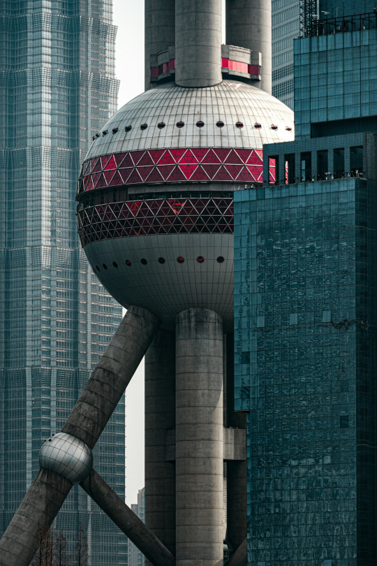 A very tall building with a red and white top