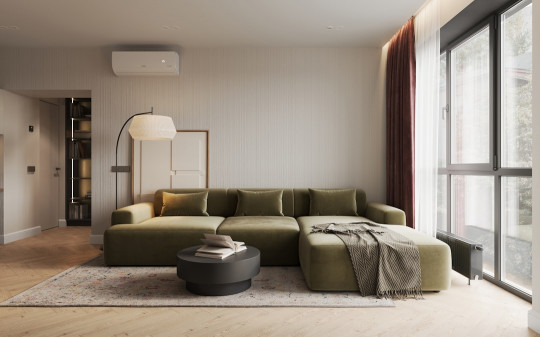 A living room with a large green couch