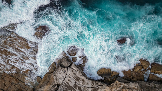 A bird's eye view of the ocean and rocks