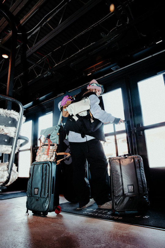 A man standing next to a pile of luggage