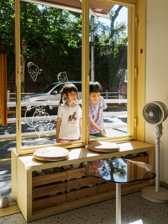 A couple of kids looking out of a window