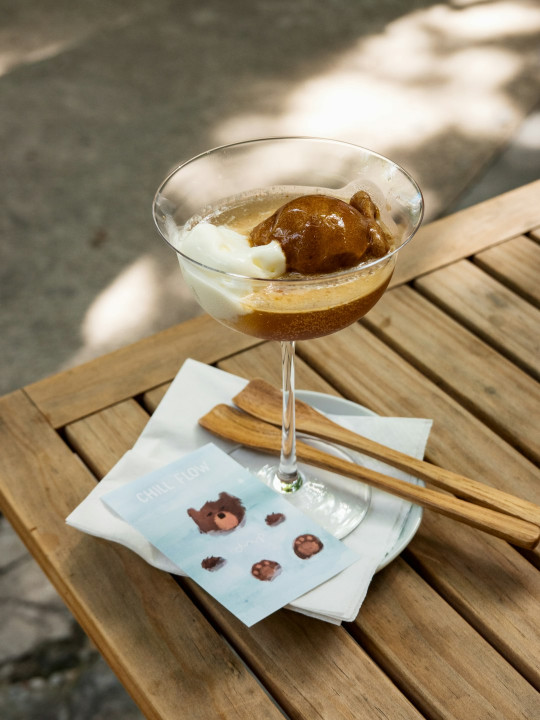 A glass of dessert sitting on top of a wooden table