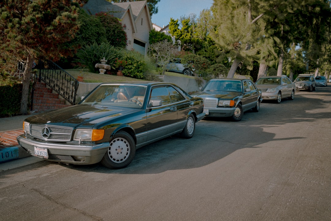 A line of cars parked on the side of a road