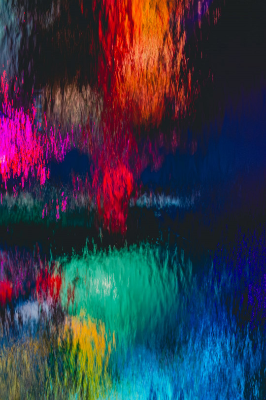 A multicolored image of water and trees