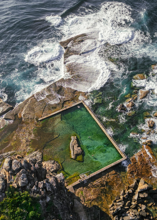 An aerial view of a body of water surrounded by rocks