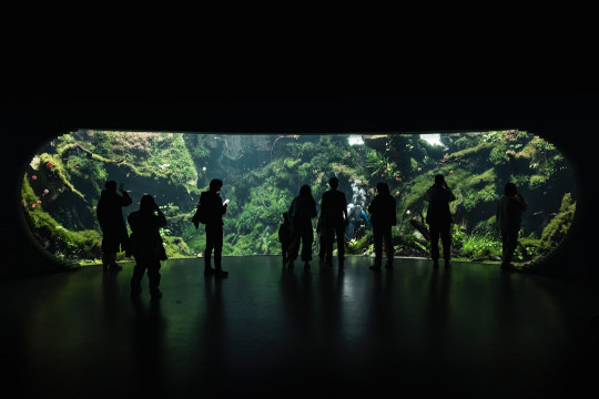 A group of people standing in a dark tunnel