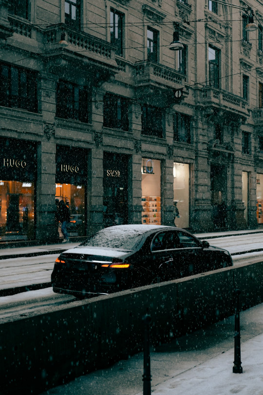 A car driving down a snow covered street