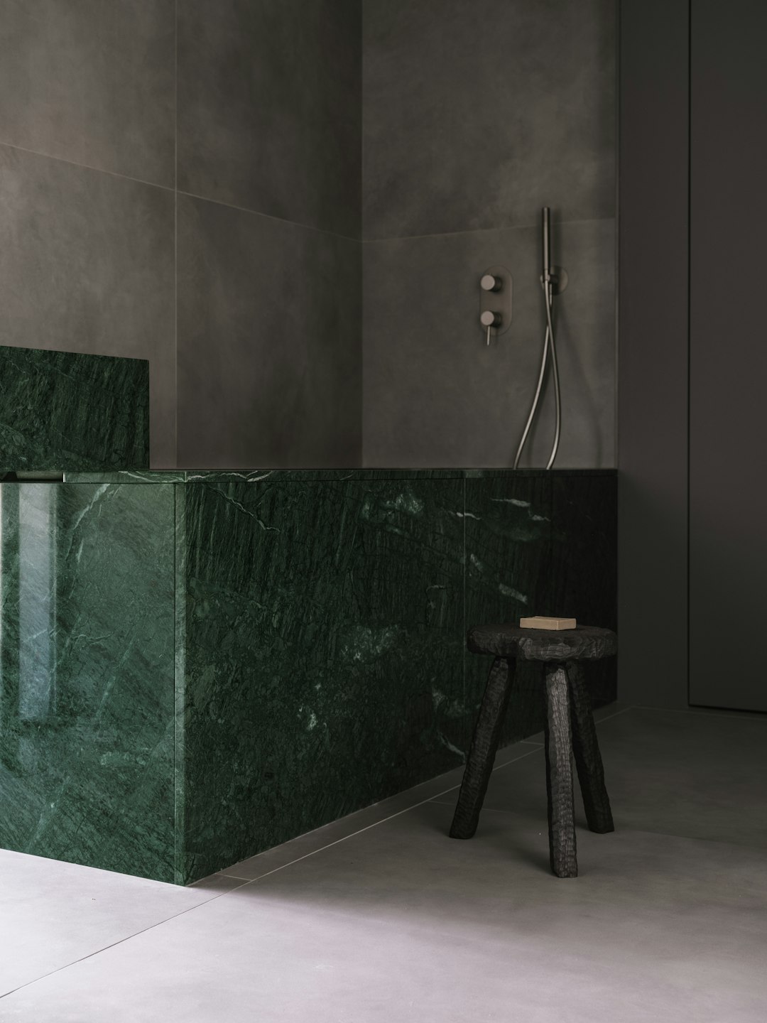 A bathroom with a green marble counter top