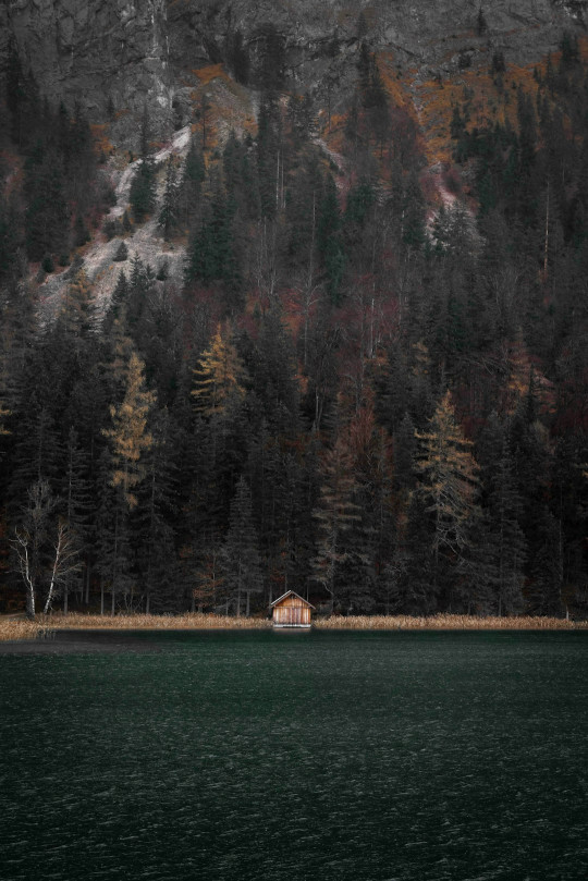 A house sitting on the edge of a body of water