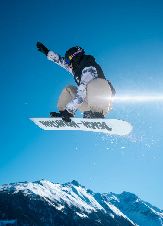 A person on a snowboard jumping in the air