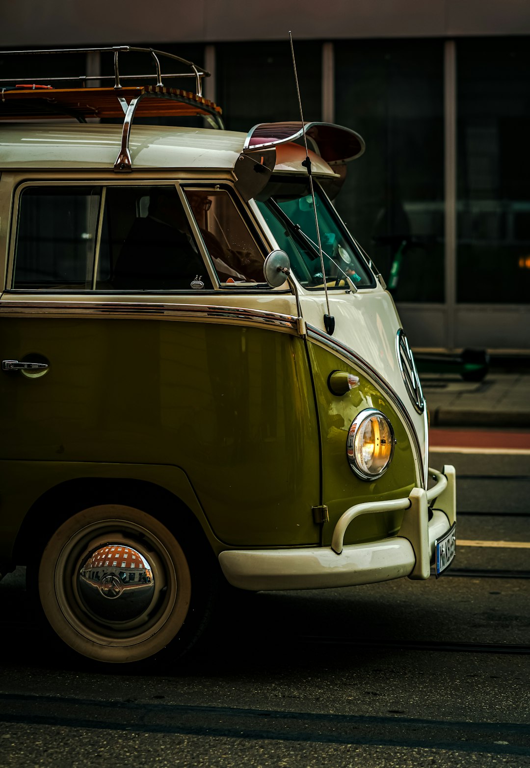 A green and white van with a surfboard on top