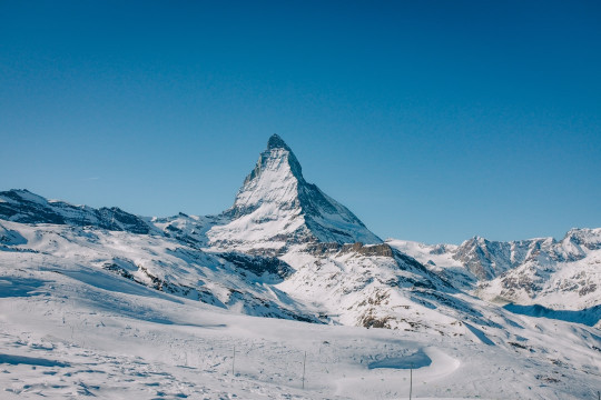 A man riding skis down a snow covered slope