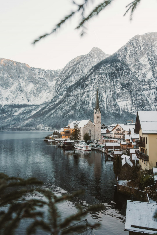 A small town on a lake surrounded by mountains