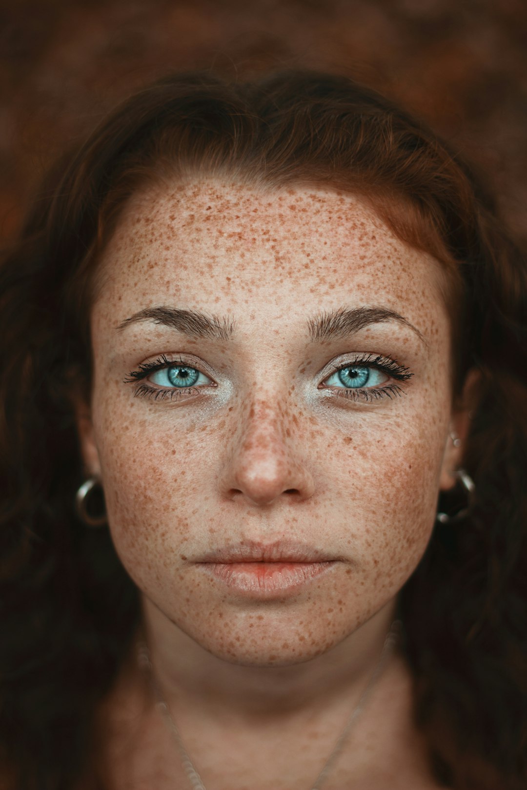 A woman with freckled hair and blue eyes