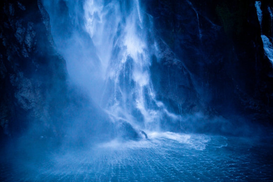 A large waterfall in the middle of a body of water