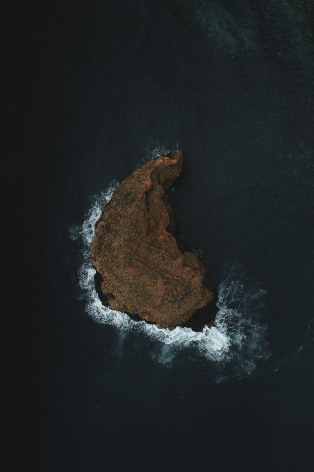 An aerial view of a rock formation in the ocean