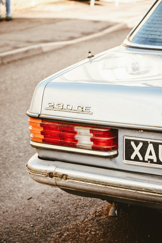 A silver car parked on the side of the road