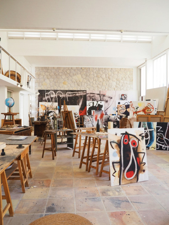A room filled with lots of art and furniture