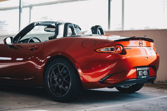 A red sports car parked in a garage