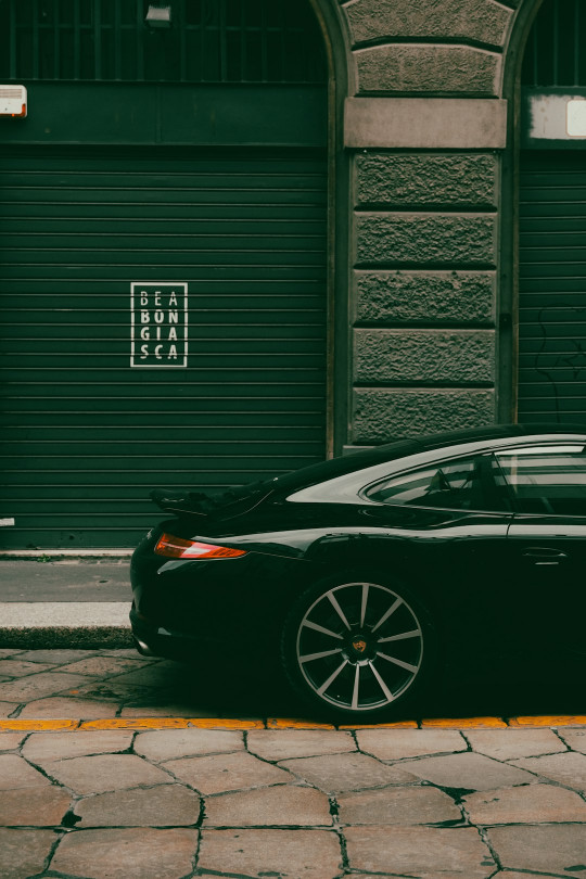 A black car parked on the side of the road