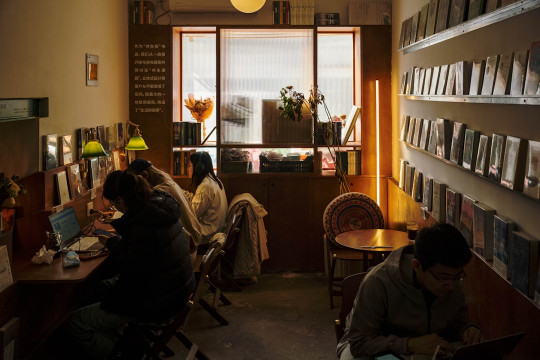 A couple of people sitting at a table in a room