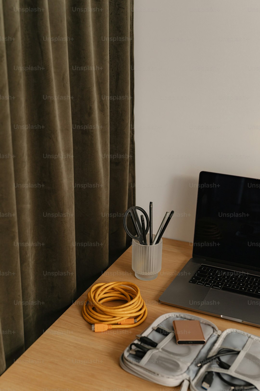 A laptop computer sitting on top of a wooden desk