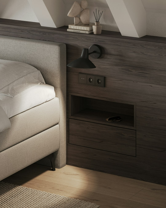 A bedroom with a bed, nightstand, and window