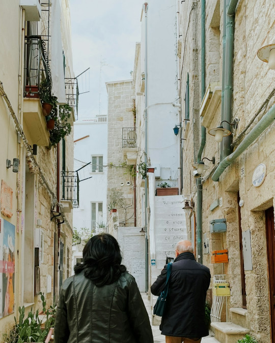 A couple of people walking down a street